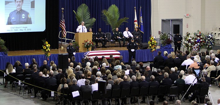 A screen projected a photo of Chief Albert Hogle while people talked about how much influence Hogle had on their careers and lives.