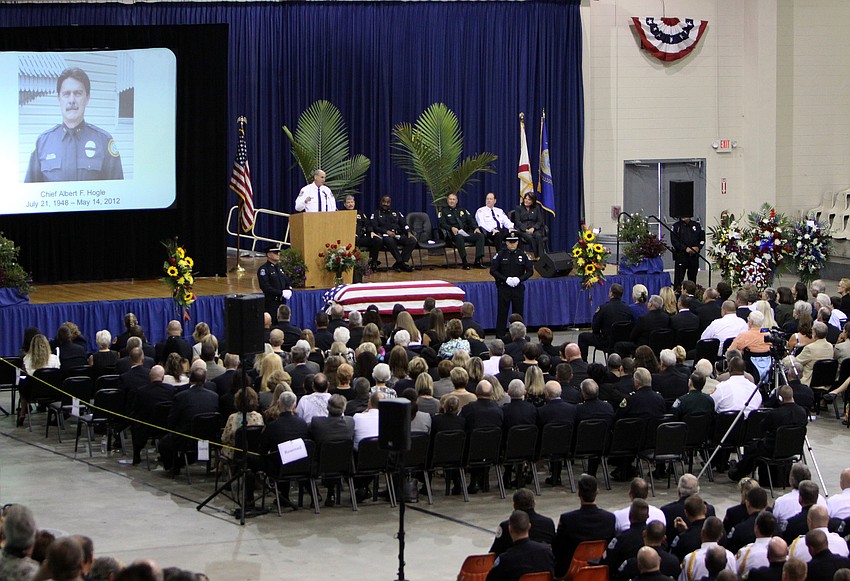 A screen projected a photo of Chief Albert Hogle while people talked about how much influence Hogle had on their careers and lives.