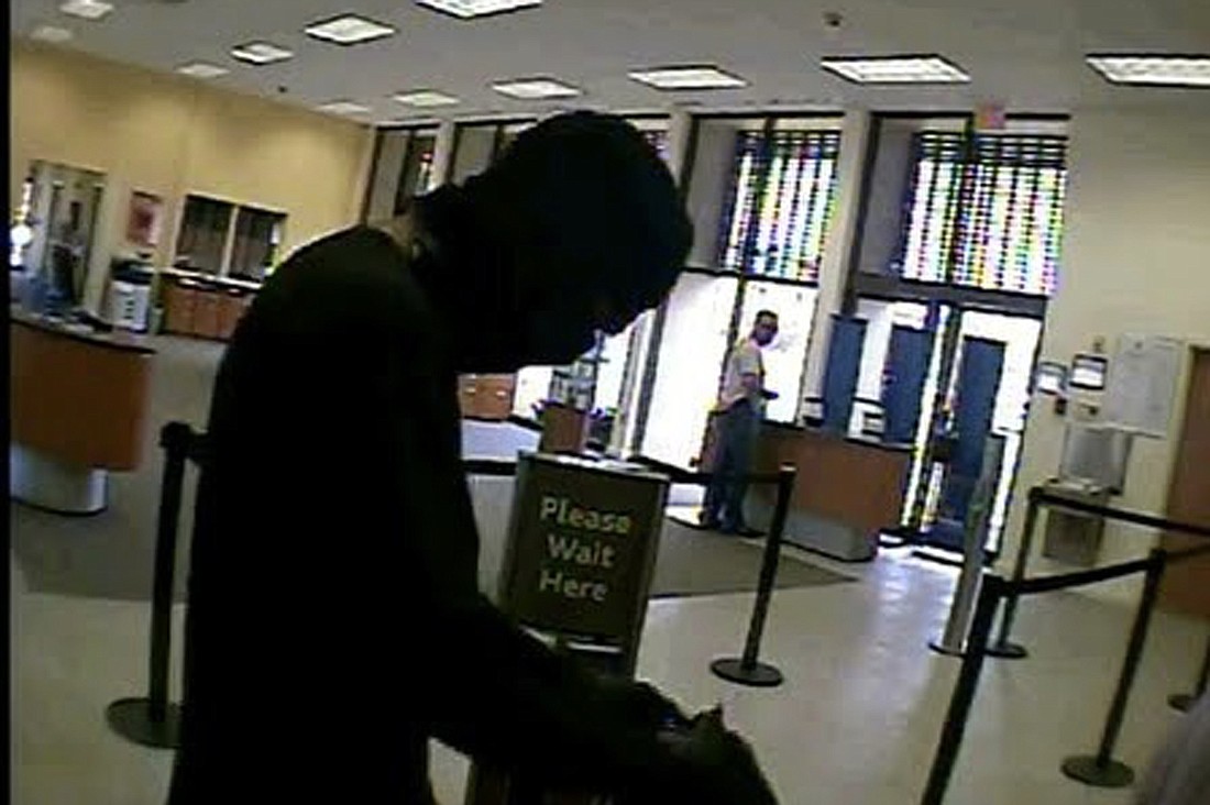 A suspect with multiple tattoos, including one on his neck, robbed a SunTrust Bank on Fruitville Road yesterday.