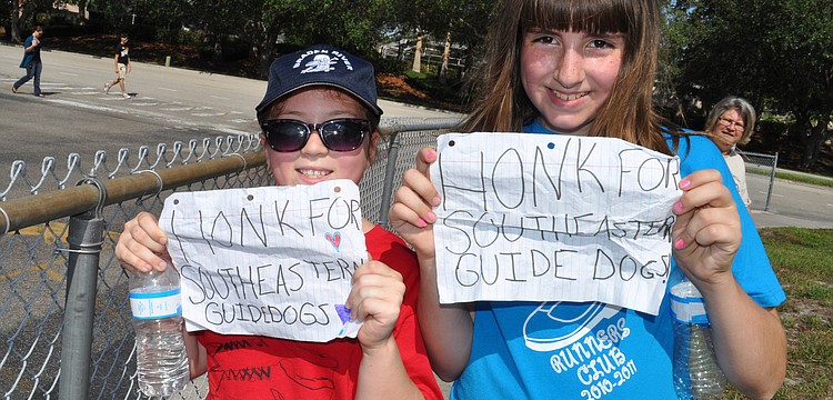 Paulina Medrzycki and Kirsten McGlaun earned about a dozen honks with their signs.