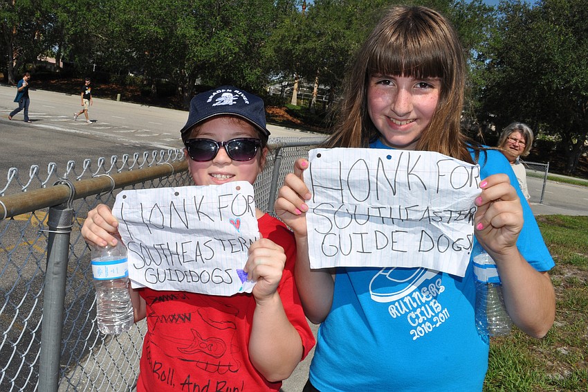 Paulina Medrzycki and Kirsten McGlaun earned about a dozen honks with their signs.
