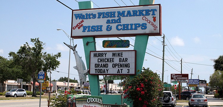 The billboard at Waltâ€™s Fish Market announced the grand opening of their new Chickee Bar.