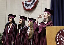 Alicia Martnelli, Elisabeth Reyes and Colleen Darby sing the Star Spangled Banner while Tiffany Faulkner signs the song, Saturday, June 2, at Riverview High Schoolâ€™s graduation at Robarts arena.