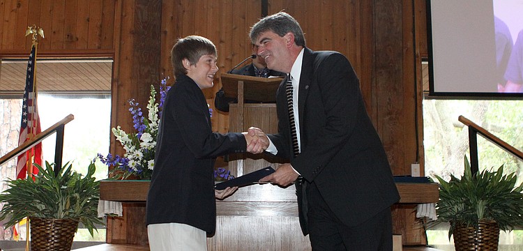 Max Munroe receives his diploma from Headmaster David Mahler, Friday, June 1, at Siesta Key Chapel.