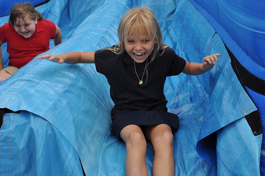 Kaylah Gunst didn't stop smiling as she went down the inflatable slide.