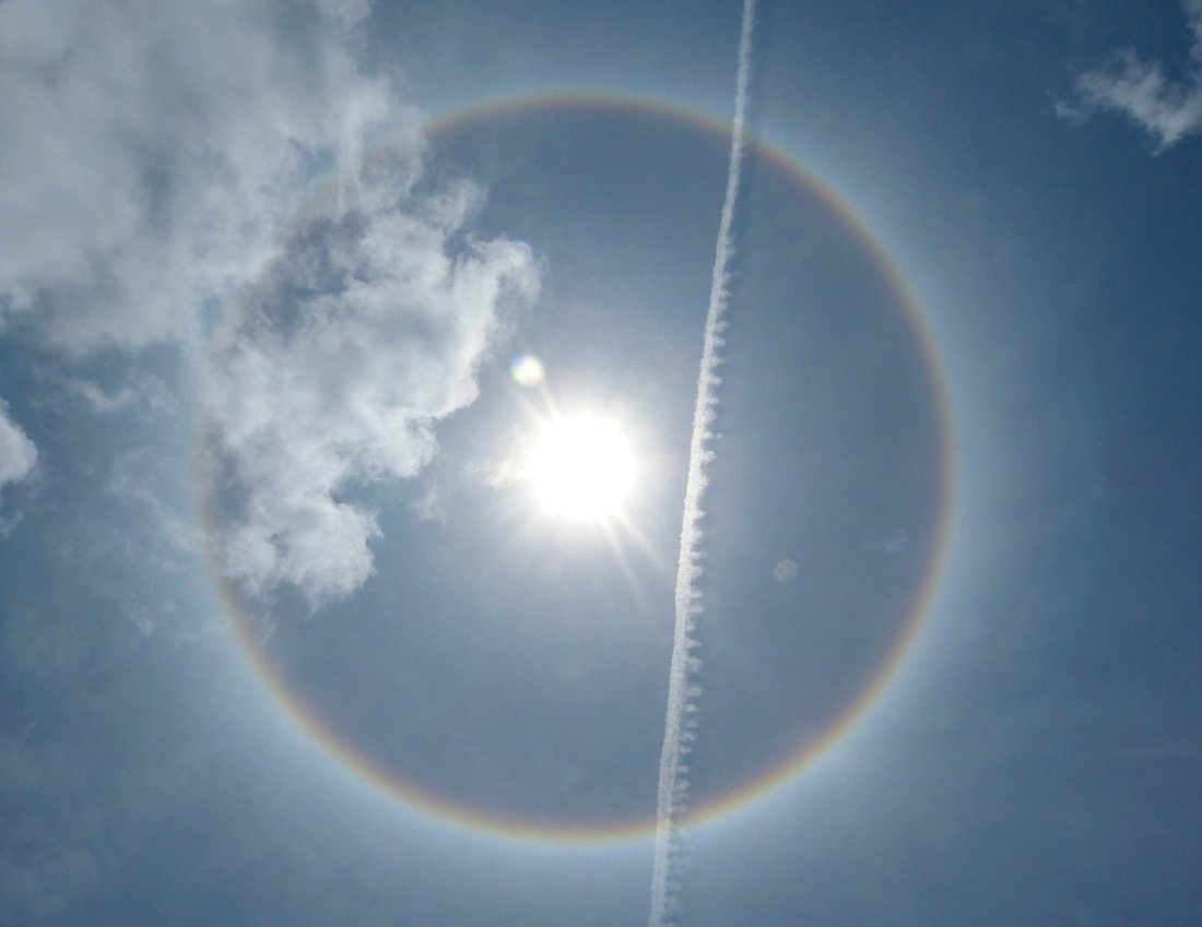 Paul Weller took this photo of a sun halo with a jet contrail and some clouds June 4, on south Siesta Key at the FishermanÃ¢â‚¬â„¢s Haven condo.