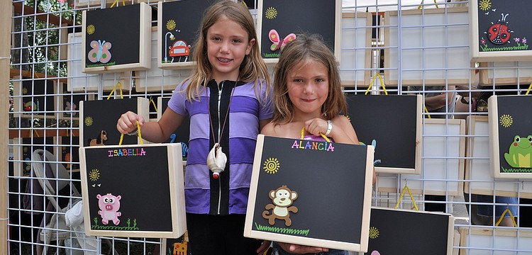 Isabella and Alancia Cox show off their purchase.