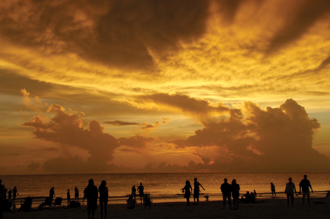 Following a birthday celebration, Therese Sutton captured the party-goers watching this sunset on Siesta Key Beach.