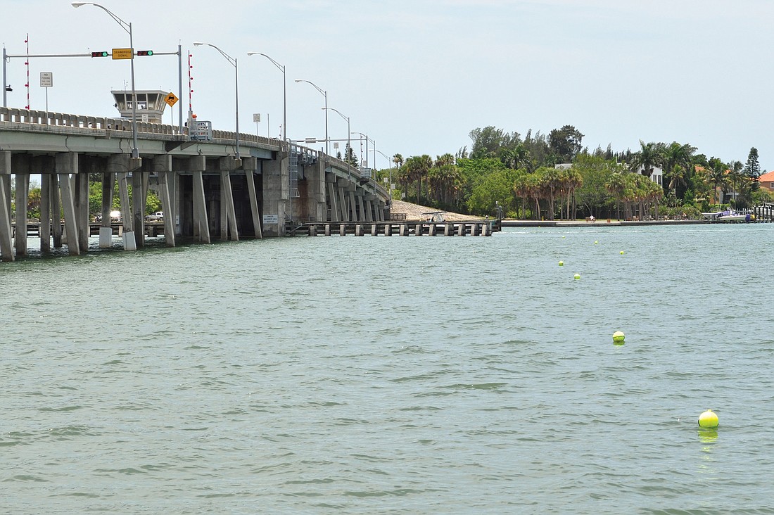 Neon buoys mark the placement barriers designed to minimize the spread of construction debris across the bottom of Sarasota Bay.