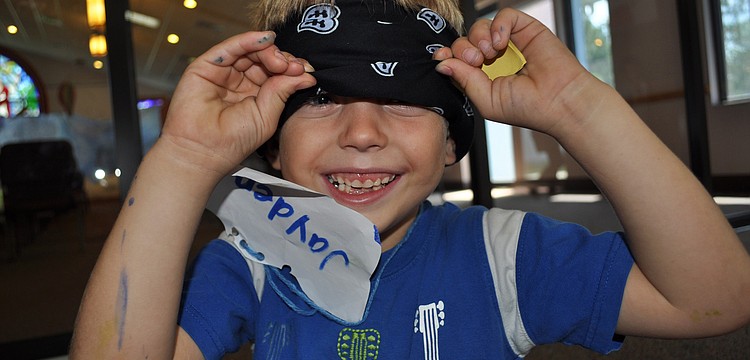 Five-year-old Jayden Jennings could not resist peaking through his blindfold as he waited for a game to start.