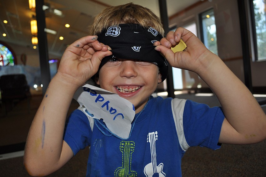 Five-year-old Jayden Jennings could not resist peaking through his blindfold as he waited for a game to start.