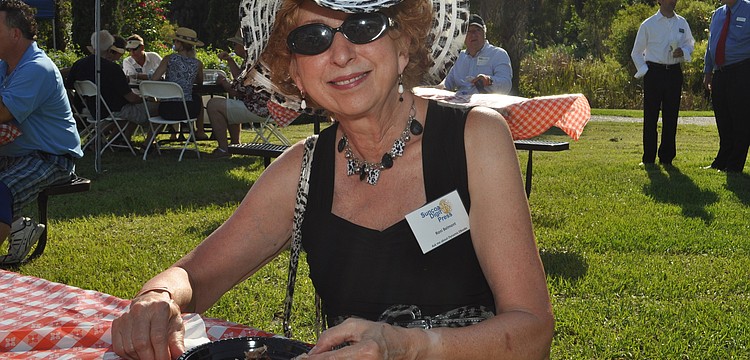 Roni Belmont with Suncoast Digital Press enjoys some ribs from Anna Maria Oyster Bar.