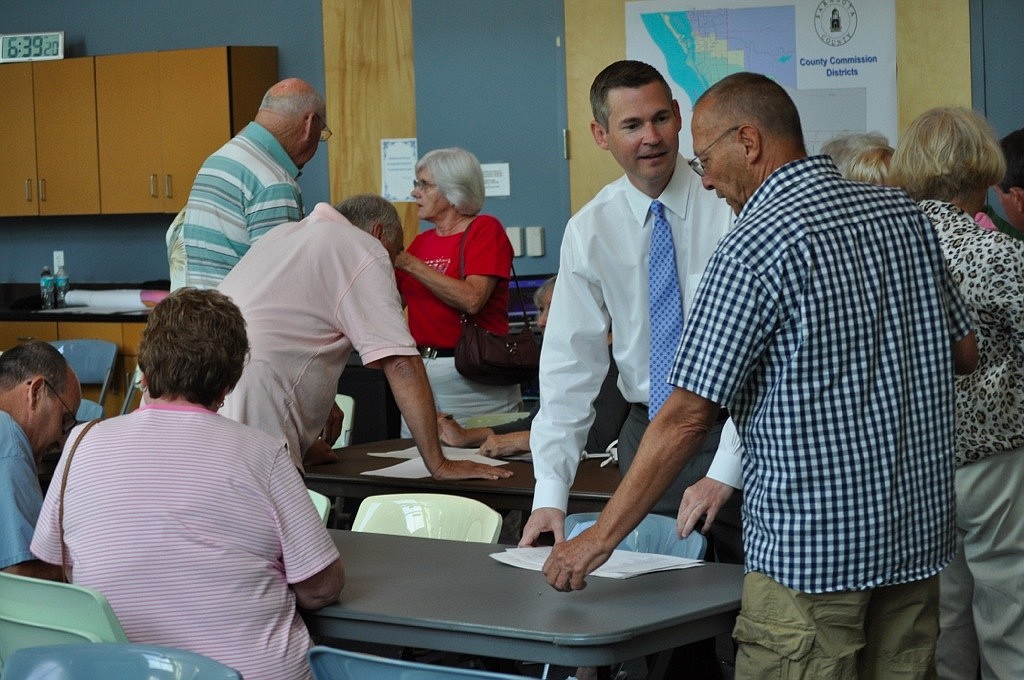 Sarasota County Supervisor of Elections Chief of Staff Ron Turner helps attendees at the June 13 Town Hall meeting determine their new precinct name and polling place.