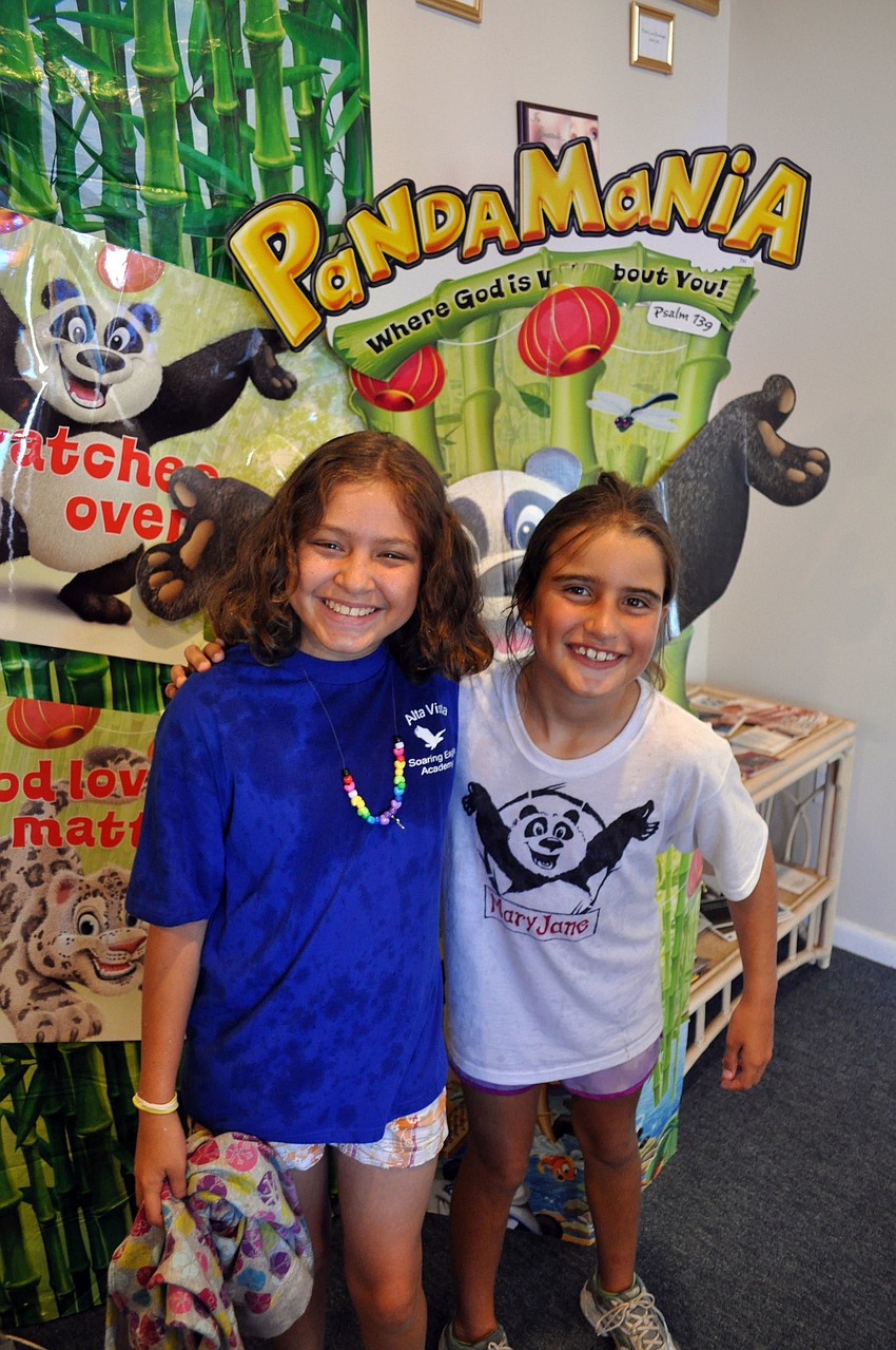 Kaitlin Thibodeau and Mary Jane Fortenberry take a break from the water fight.