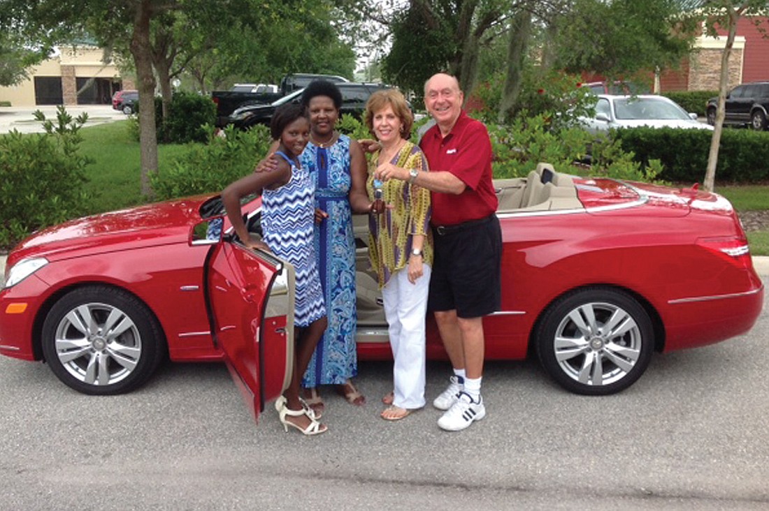 M'Balia and Cheryl Bangoura stand with the Bangouras' new convertible with Lorraine and Dick Vitale. Courtesy photo.
