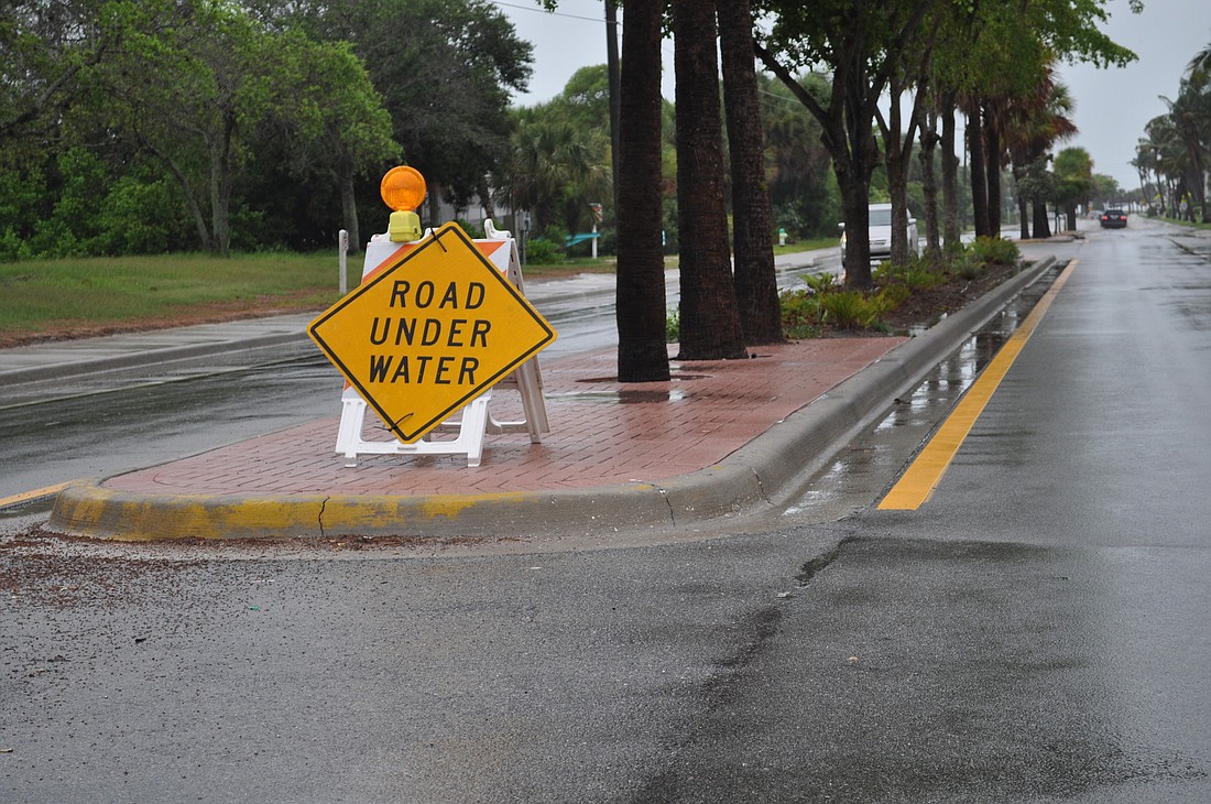 Sarasota County placed signs warning of the heavy flooding on Beach Road brought on by the constant weekend rain.