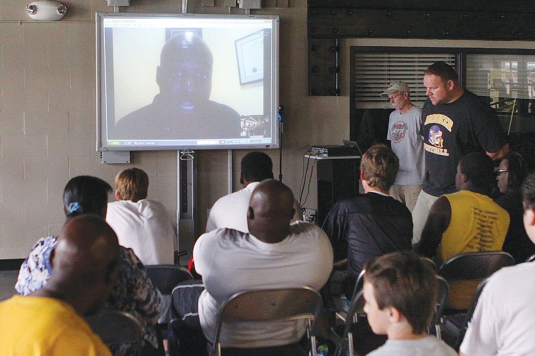 New Booker High head football coach Carlos Woods Skyped in Tuesday night to introduce himself to players.