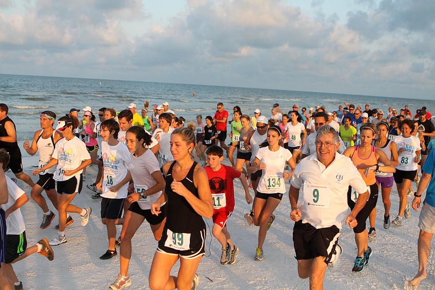 The runners start the race, Saturday, June 30, out on Siesta Key Public Beach.