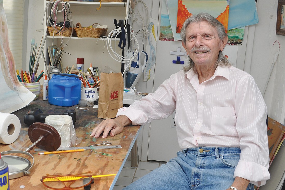 I. Bert Spiegel sits in his studio, located on the lanai, where he paints and conducts small repairs.