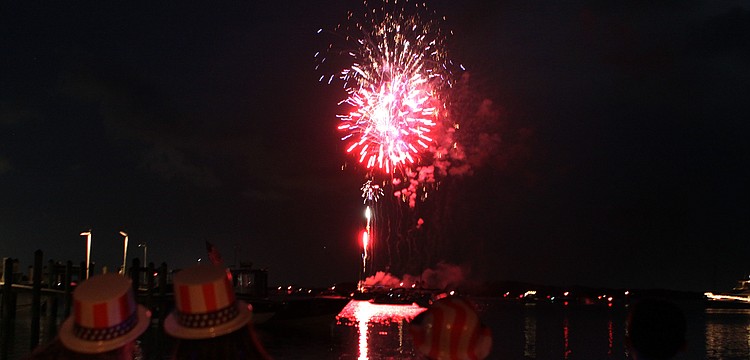 Children wore patriotic, plastic hats while sitting on the beach at Mar Vista, Monday, July 2, during the 4th annual Boom Boom on the Bay.