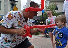 Balloon artist Trebor Britt poked 3-year-old Dylan Durrance with his new sword.