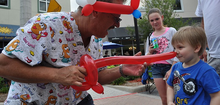 Balloon artist Trebor Britt poked 3-year-old Dylan Durrance with his new sword.