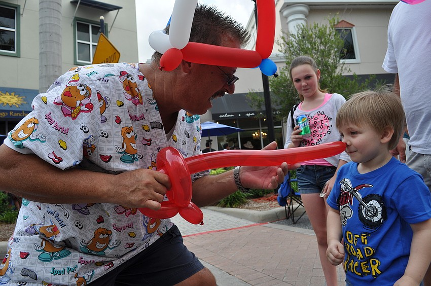 Balloon artist Trebor Britt poked 3-year-old Dylan Durrance with his new sword.