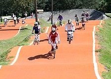 All the race participants rode around the course with American flags during the playing of the National Anthem, Saturday, July 7, at Sarasota BMX during Olympic Day.