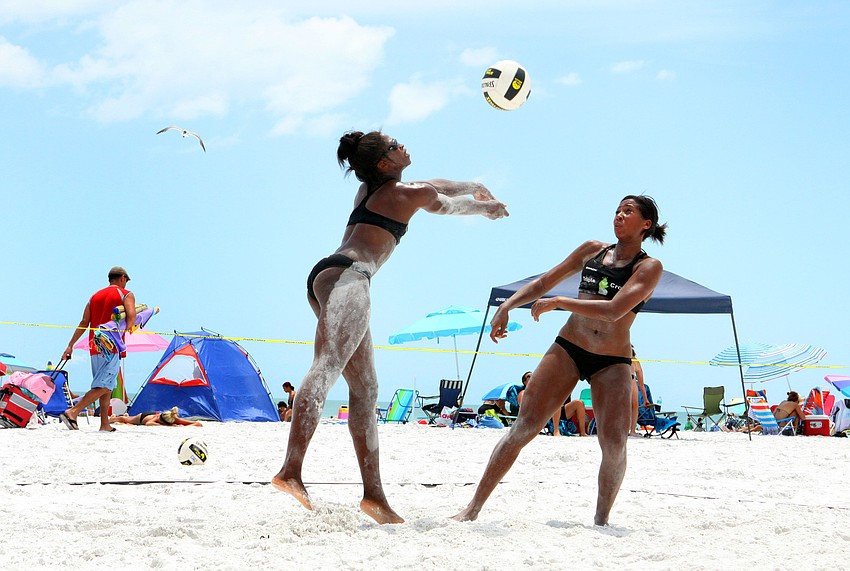 Chibuzo Aguocha goes for the ball as Larissa Witherspoon stays close during a match, Saturday, July 14, during the Dig the Beach tournament on Siesta Key Beach.