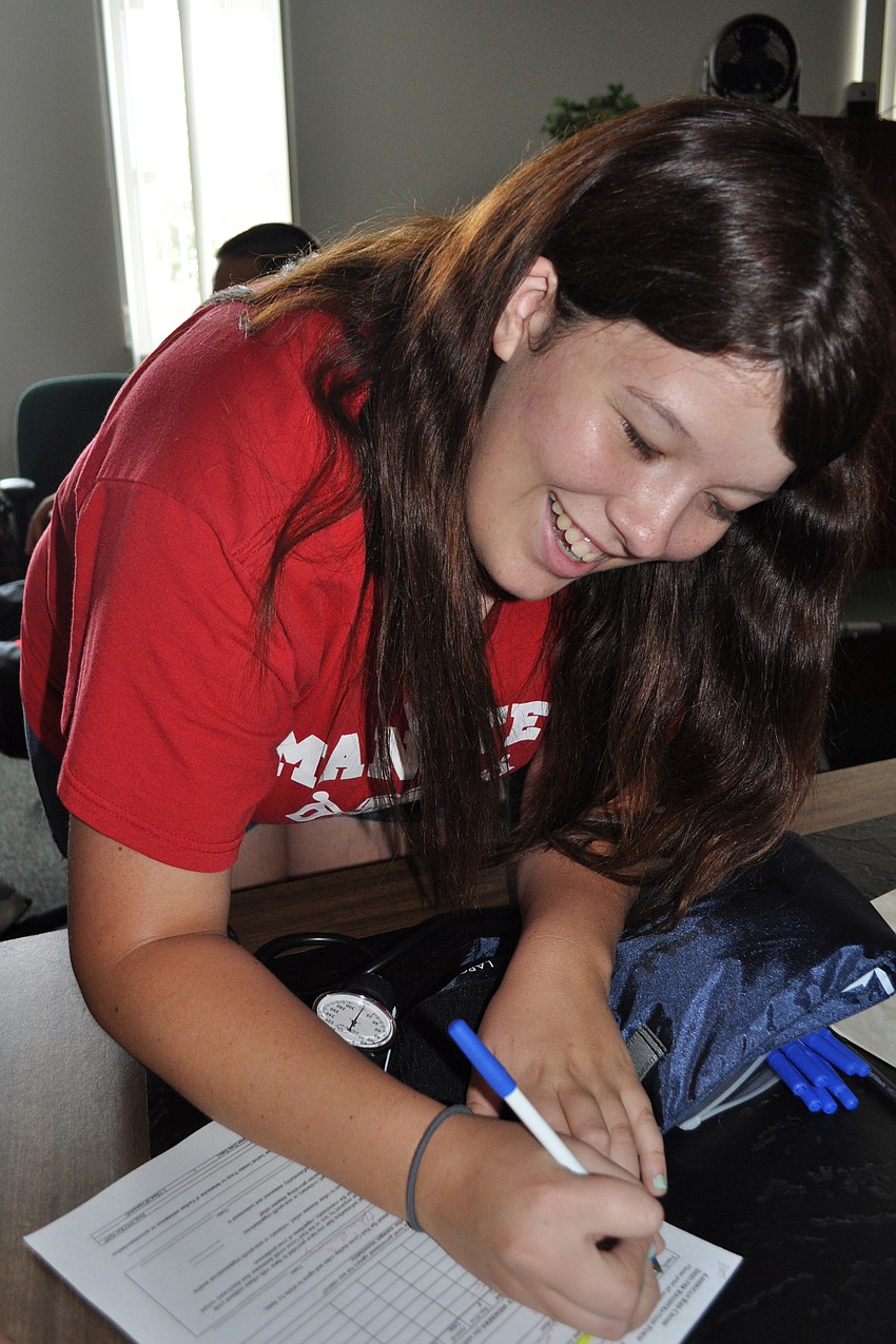 Alex Servia filled out paperwork for disaster victim.