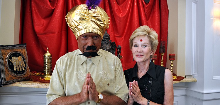 Bill and Cathy Goshorn pose at the entrance of Bird Key Yacht Club, Saturday, July 21, before partaking in the Passage to India event.