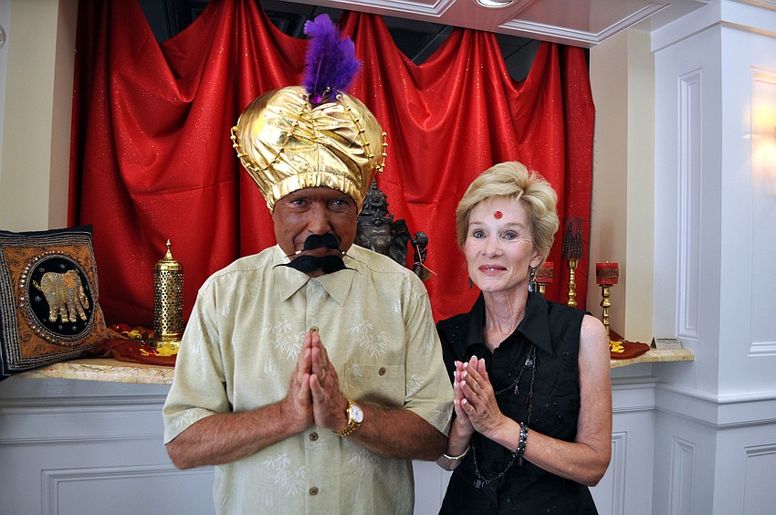 Bill and Cathy Goshorn pose at the entrance of Bird Key Yacht Club, Saturday, July 21, before partaking in the Passage to India event.