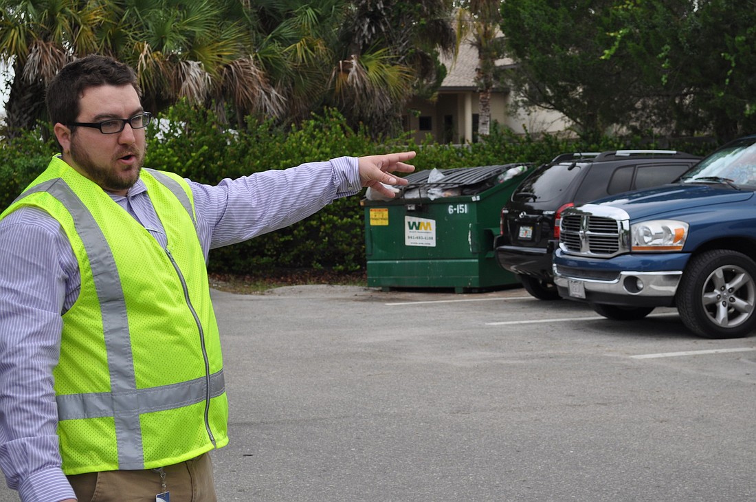 Ryan Montague, a staff member in Sarasota Count Traffic Engineering, shows representatives a dumpster their firms will oversee during an annual contract for Siesta Key Village maintenance.