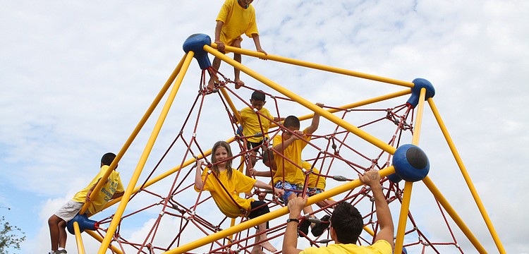 Nathaniel Garcia, 8, Sage Scrimle, 7, Halee Beckwith, 7, Thomas Garcia, 6, and Tyler Helm, 9, look down from above and talk to camp counselor Myles Webb, Wednesday, July 18, out at Central Park during Bible Baptist Summer Camp.