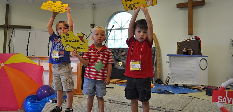 Jake Stanton, Jake Johnson and Zach McClung held lead children in a song.