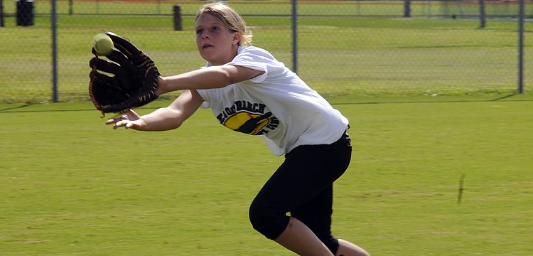 Thirteen-year-old Madison Yoder works on fielding drills.