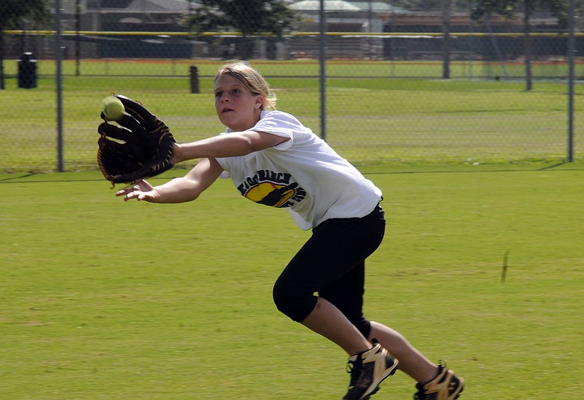 Thirteen-year-old Madison Yoder works on fielding drills.