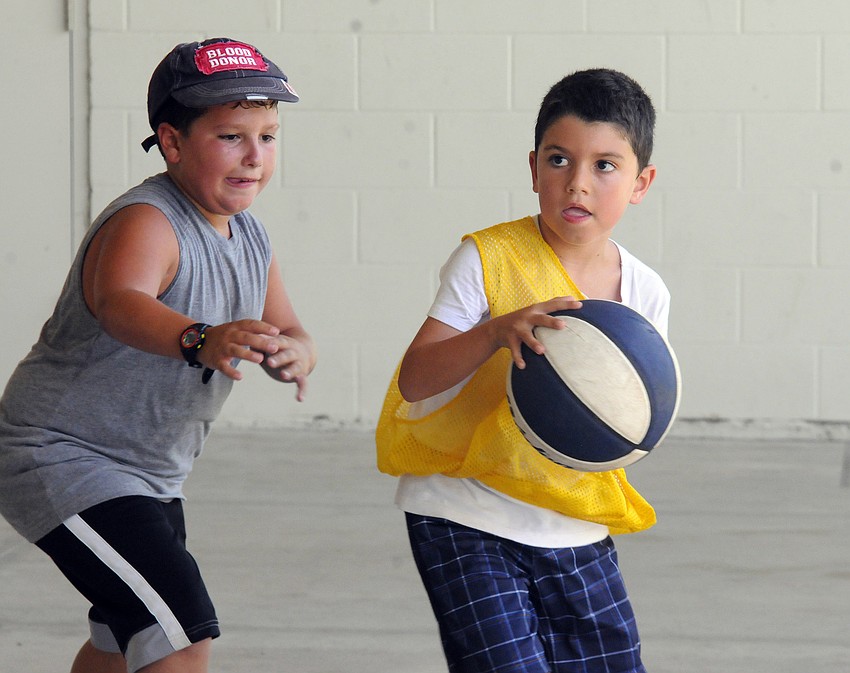 Seven-year-old Antonio Archila looks to dribble past defender Rafael Alonso.