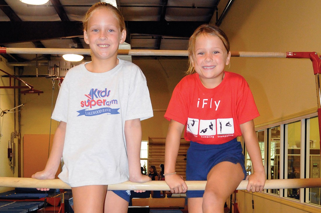 Nine-year-old Ava Frank and her 6-year-old sister Ally say their favorite part about gymnastics is flipping around the uneven bars. The two sisters will compete for Kids SuperGym's level 3 team this year.