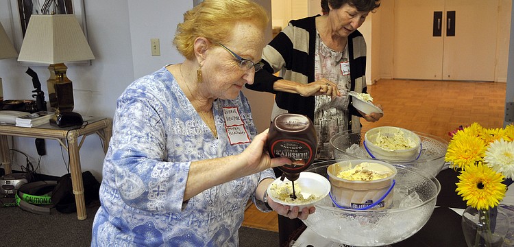Hannah Puckerhaber and Jane Greenfield make themselves some sundaes, Sunday, Aug. 5, during Temple Beth Sholomâ€™s open house and ice cream social.