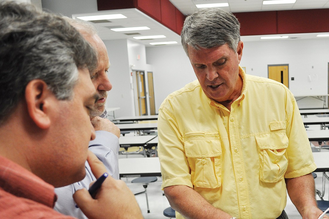 Ben Jordan, center, reviews the conceptual plans with other attendees. Photos by Pam Eubanks.