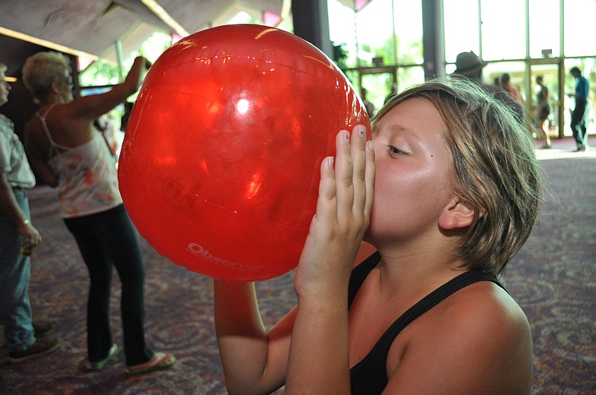 Bailey Brooks blows up an Observer beach ball