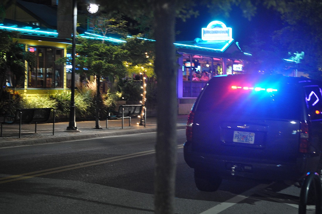 An undercover Sarasota County Sheriff's Office vehicle responds to reports of a fight at Daiquiri Deck Raw Bar in Siesta Key Village last night.