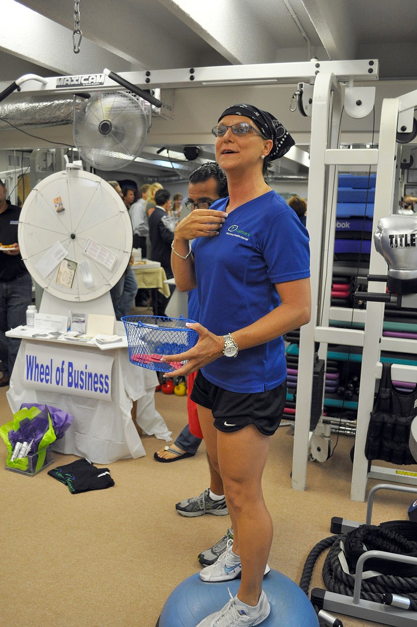 Yvette Bernosky, owner of Yvetteâ€™s Health and Fitness Center, calls out the names of raffle-prize winners.