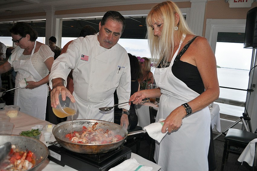 Alfredo Loza pours in one of the ingredients into Tami Richardsâ€™ saucepan, Friday, Aug. 17.