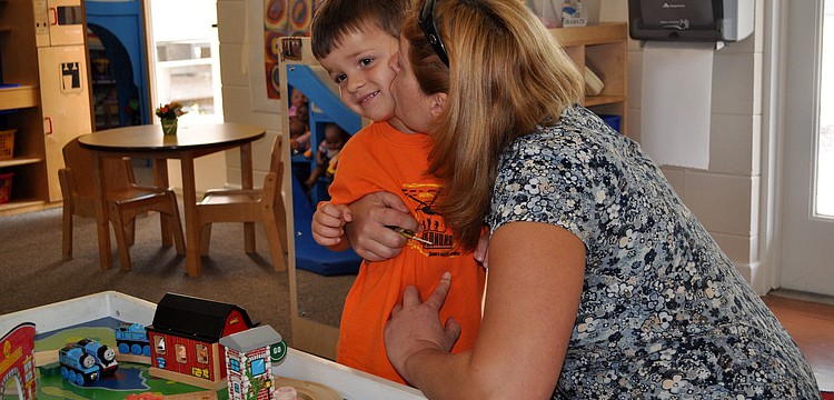Olga Carr gives her son, Sean, 3, a hug and a kiss goodbye before leaving him at his first day of school for the year at St. Boniface Preschool.