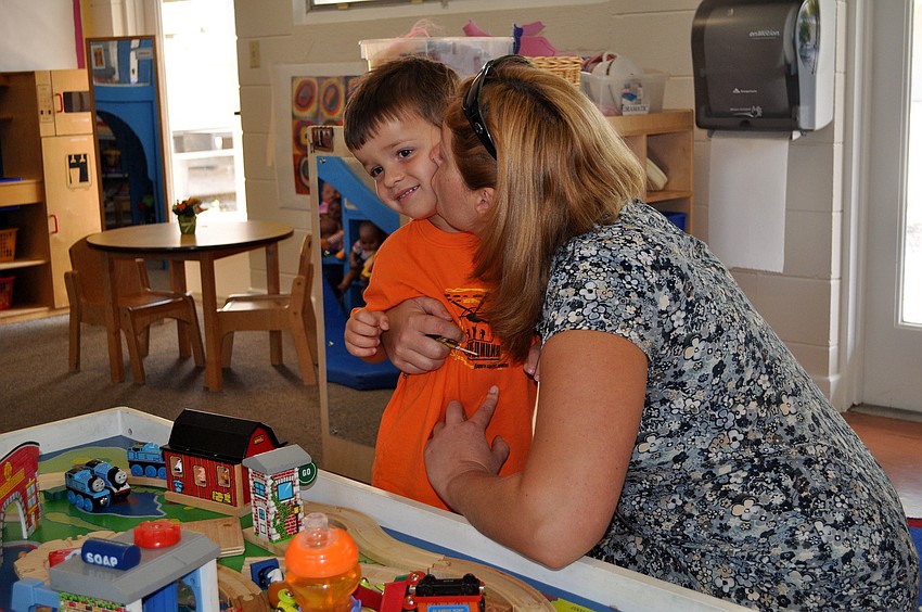 Olga Carr gives her son, Sean, 3, a hug and a kiss goodbye before leaving him at his first day of school for the year at St. Boniface Preschool.