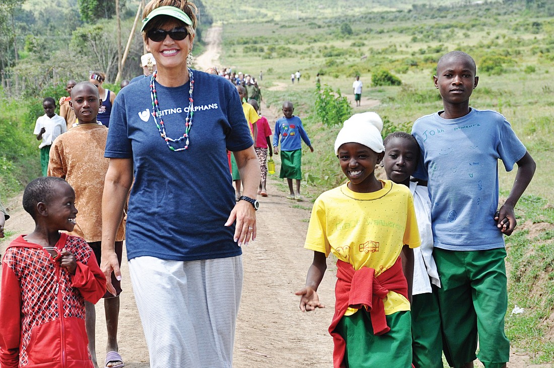 Beth Barnett takes a nature walk with the children of Fiwagoh Orphanage in Narkuru, Kenya. Photo by Ashlie Fulmer.