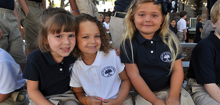 Madison Romito, Kirin Malisoff and Alexa Gettel, 5, pose together on the bleachers, Wednesday, Aug. 22, the first day back to school at Out-of-Door Academy.