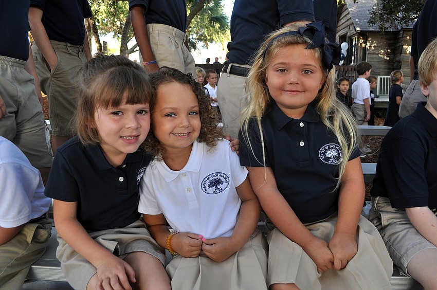 Madison Romito, Kirin Malisoff and Alexa Gettel, 5, pose together on the bleachers, Wednesday, Aug. 22, the first day back to school at Out-of-Door Academy.